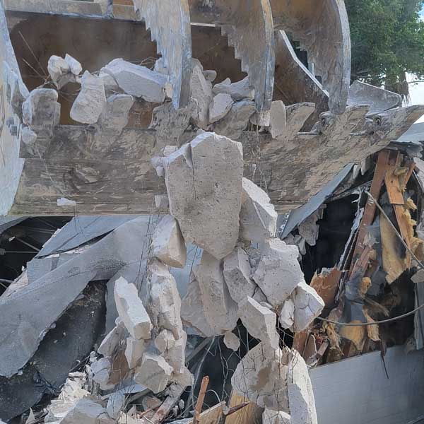 Demolition debris being lifted by a claw.