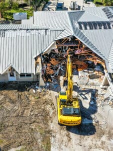 Demolition of a house with an excavator.