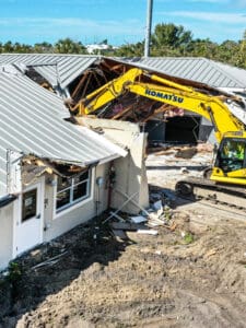 Demolition of building with excavator.